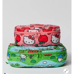 three hello kitty suitcases stacked on top of each other in different colors and designs