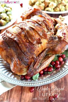 a roasted turkey on a platter with cranberries and brussel sprouts