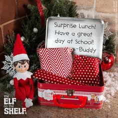 an elf is sitting next to a christmas tree with presents in it and the caption says, surprise lunch have a great day at school buddy