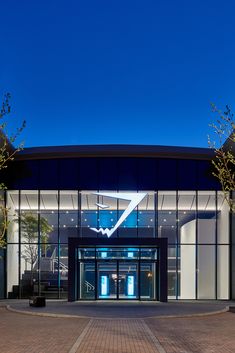 the entrance to a modern building lit up at night