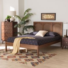 a bed sitting on top of a wooden floor next to a dresser and chest of drawers