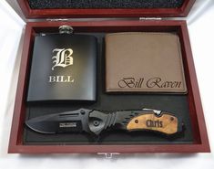 an open box containing a knife, flask and wallet with the name bill raney written on it