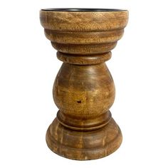 a wooden vase sitting on top of a white surface