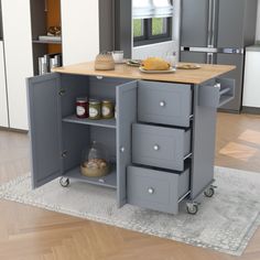 a kitchen island with three drawers on wheels