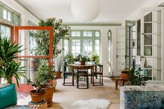 a living room filled with furniture and lots of plants