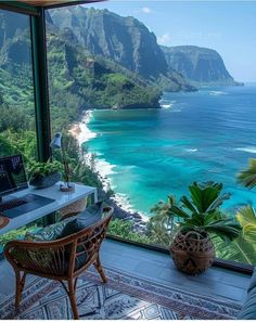 a desk with a laptop on it in front of a large window overlooking the ocean