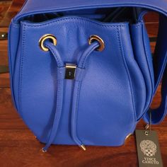 Vince Camuto Dazzling Blue Drawstring Bag Luxury Blue Bucket Bag For Daily Use, Luxury Blue Shoulder Bucket Bag, Luxury Blue Bucket Bag For Shopping, Luxury Blue Bucket Bag, Blue Backpack For Shopping, Luxury Blue Bucket Bag With Adjustable Strap, Luxury Blue Backpack Bag, Luxury Blue Backpack, Blue Luxury Pouch Bucket Bag