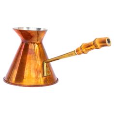 an old fashioned brass coffee pot with a wooden handle