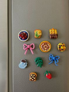 the magnets on the refrigerator are decorated with different foods and desserts, including cookies