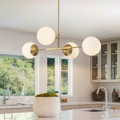 a modern kitchen with marble counter tops and an island in front of the sink area