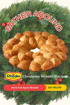 a christmas wreath made out of bread with the words gather around in red and yellow