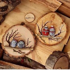 two little owls sitting on top of a piece of wood next to another owl figurine