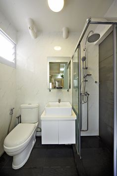 a bathroom with a toilet, sink and shower