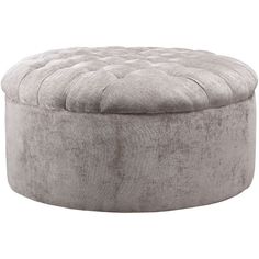 a round ottoman that is made out of grey velvet with an upholstered top