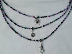 These lovely single strand beaded necklaces are great for adding a pop of colour. It is made using a variety of black, purple and green beads with a lovely tibetan silver charm. Great to add to your Halloween outfit 🎃🎃 This necklace is 16 inches in length and t length (diameter) of the necklace is including the clasps and endings so please measure carefully to ensure the necklace will fit you.  A 5cm extension chain can be added if you would like the option to have it that bit longer. I do hav Purple Beaded Necklace With Round Black Beads, Adjustable Beaded Necklace For Halloween, Halloween Adjustable Round Bead Necklaces, Halloween Necklace With Round Beads, Purple Necklace With Black Beads, Purple Beaded Necklace With Black Beads For Gift, Halloween Gift Beaded Necklaces With Round Beads, Halloween Gift Beaded Necklace With Round Beads, Halloween Gift Round Beads Necklace