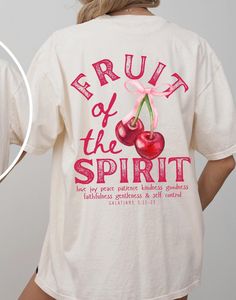 Trendy Christian Fruit of the Spirit, coquette cherries bible verse graphic tshirt for summer. Print on the back. Available in the colors: Ivory, Pepper, White Black, Moss, & Espresso. Comfort Colors unisex fit.  Size up for an oversize fit.  The soft-washed, garment-dyed fabric brings extra coziness to your wardrobe while the relaxed fit makes it an excellent daily choice.  ~made with 100% ethically grown, ring-spun US cotton for long-lasting comfort. ~relaxed fit  ~pre-shrunk fabric ensures a Fruit Of The Spirit Shirt, Trendy Pink T-shirt With Fruit Print, Summer Crew Neck T-shirt With Fruit Design, Fruit Of The Spirit Tshirt, Fun White T-shirt With Fruit Print, Spring Fruit Design Cotton T-shirt, Bible Shirts, Faith Clothing, Spirit Shirts