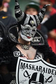 a person wearing a mask and holding a sign