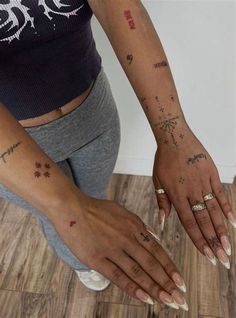 a woman with tattoos on her arm and hand