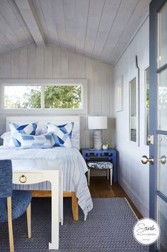 a bedroom with white walls and blue accents