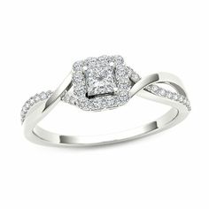 a white gold ring with diamonds on the band and a square shaped diamond in the center