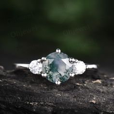 "This is a moss agate engagement ring in solid gold,about 7mm round cut. The accent stones are round 3mm moissanites. It can be made in any ring size. However please contact me to custom make it to a special big or small size. It can be made in white gold,rose gold or yellow gold with 14k or 18k. However for some people who are nickel allergic,I can also make it to 925 sterling silver to make you can wear it. The ring is handmade,very high quality! 30 days money back guarantee. Returns & War Fine Jewelry Moissanite With Prong Setting, Timeless 14k White Gold Jewelry With Round Stone, Timeless Diamond White Jewelry With Gemstone, Unique Three-stone Ring Jewelry, 14k White Gold Round Cut Promise Ring, Timeless Gemstone Jewelry For Weddings, Timeless Handmade Jewelry For Wedding, Handmade Timeless Jewelry For Wedding, Timeless Jewelry Ring With Prong Setting