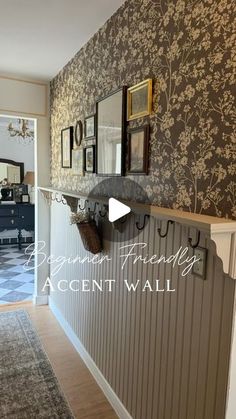 a hallway with wallpaper and pictures on the walls, along with an accent wall