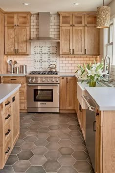 a kitchen with wooden cabinets and tile flooring