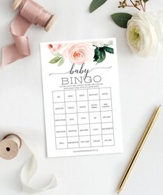 a baby shower game with pink flowers and greenery