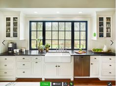 a kitchen with white cabinets and black counter tops is pictured in this image from the inside