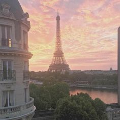 the eiffel tower is seen from across the river in paris, france at sunset