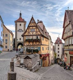 a cobblestone street lined with tall buildings