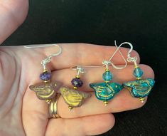 Looking for something cute to wear this spring? These cute little birds are ready to accompany you on your latest adventure. They are hand made with imported Czech glass bird beads, gold plated seed beads and sterling silver ear wires; they are stylish, cute and comfortable to wear. The blue birds are accented with pretty Swiss blue crystals, while the purple birds are accented with genuine semiprecious chariote beads. Made in my little house in NJ and supervised by our new kitty Catman. Thanks for looking! Czech Beads Jewelry, Purple Birds, Purple Bird, Earrings Ideas, Bird Beads, Diy Bracelet Designs, Blue Birds, Earring Ideas, Bird Earrings