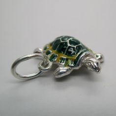 "This three-dimensional, sterling silver Turtle charm is exquisitely hand-enameled in green, yellow, black, and silver. \"Slow Poke\" is inscribed on his belly. Vintage and in brand new, never worn condition. Made by Brown County Silver. 7/8\" long 3.8 grams See more @ https://www.etsy.com/shop/brocosi" Green Jewelry With Black Enamel As A Gift, Green Jewelry With Black Enamel For Gift, Green Enamel Jewelry With Polished Finish, Green Enamel Jewelry With Charms, Green Enamel Charm Jewelry, Turtle Shaped Sterling Silver Jewelry Gift, Silver Turtle Jewelry, Silver Turtle Necklace For Gift, Sterling Silver Turtle-shaped Rings