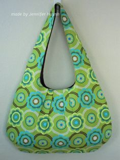 a green and blue purse hanging on the wall