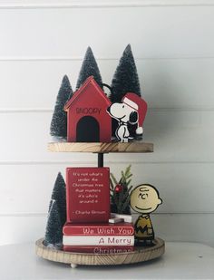 a charlie brown christmas card holder with peanuts and snoopy on top, sitting on a shelf