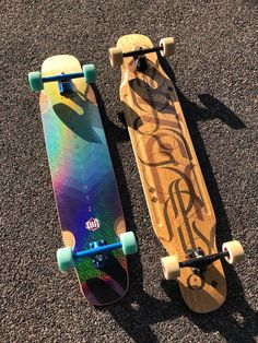 two skateboards laying side by side on the ground