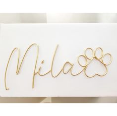 a white box with gold lettering and a dog's paw on the front that says mias