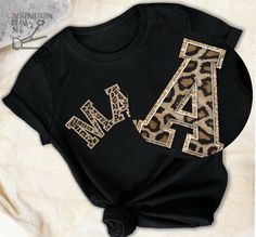 a t - shirt with the letter a and an animal print is shown on a white background