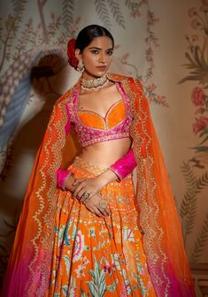 Editor's Note The tangerine noorani lehenga set is a stunning ensemble that radiates elegance and charm. The lehenga features intricate noorani embroidery in vibrant tangerine hues, creating a striking contrast against the rich fabric. Paired with a complementary blouse and dupatta, this set exudes grace and sophistication. Color: Orange Fabric: Lehenga & blouse: raw silk, dupatta: organza Components: Lehenga, blouse and dupatta Occasion: Haldi mehndi and sangeet Disclaimer: Product color may sl Orange Lengha, Orange Bridal Lehenga, Sheer Dupatta, Orange Lehenga, Mehendi Outfit, Printed Embroidery, Indian Colours, Floral Lehenga