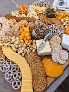 an assortment of cheeses and crackers on a platter