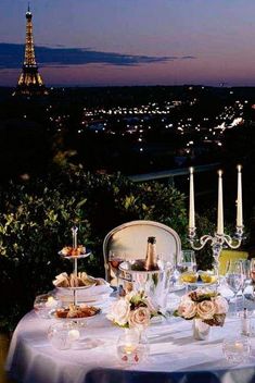 the table is set for dinner overlooking the eiffel tower in paris, france