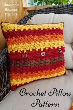 a crochet pillow sitting on top of a chair