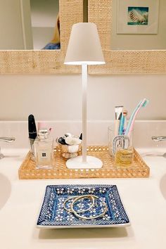 the bathroom sink is clean and ready to be used as a vanity mirror, toothbrush holder, and soap dispenser