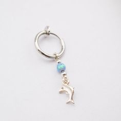 Fake Belly Ring Clip On with Opal and a Dolphin Charm Just clip the spring hoop on your navel and you're ready to go! This beautiful fake belly piercing looks just like the real thing, featuring a vibrant opal bead and a Dolphin charm. ► Hoop size is 8.5-9 mm ► Opal bead: green / white / light blue / blue / pink ► Hoop Material: silver plated / surgical steel (silver) ► Dangle Material: sterling silver ► Nickel Free ► Tarnish Resistant ► No Allergic reaction ► 30 days return policy ► Accept repl Silver Hoop Belly Rings, Fake Belly Button Piercing, Fake Belly Ring, Fake Belly Piercing, Belly Button Piercing Rings, Piercing Clip, Dolphin Charm, Blush Jewelry, Silver Ear Climbers