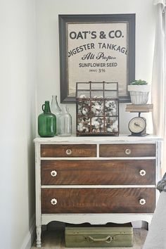 an old dresser is painted white and brown