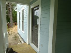 a dog is sitting on the front porch