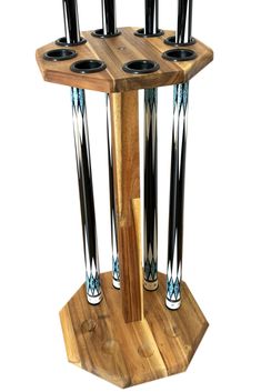 a wooden stand with four black and white vases on it's sides,