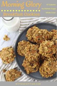 a plate full of granola cookies next to a glass of milk on a table