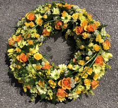 an orange and yellow wreath on the ground