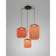 three orange lights hanging from a ceiling fixture